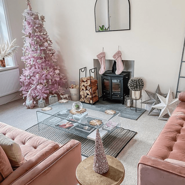 living room with a pink christmas tree on the left corner