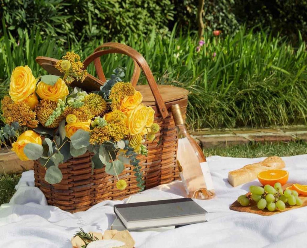 cottagecore picnic basket flower arrangement