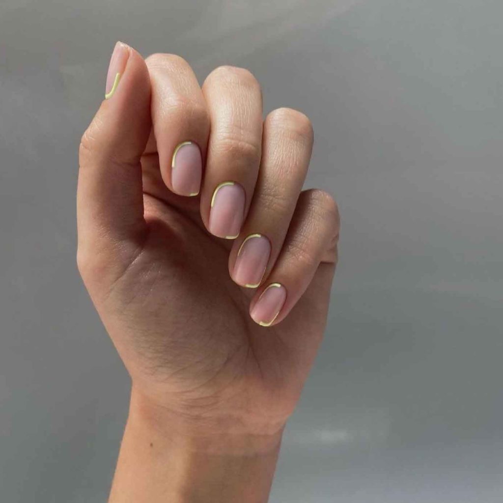 nude nails with gold accent