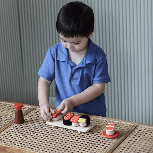 asian boy playing with sushi toy set non toxic play food plan toys