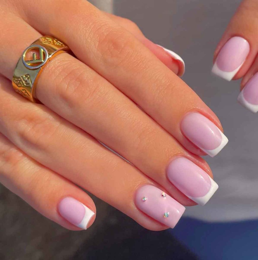 light pink nails with white french tips and diamonds on medium square nails